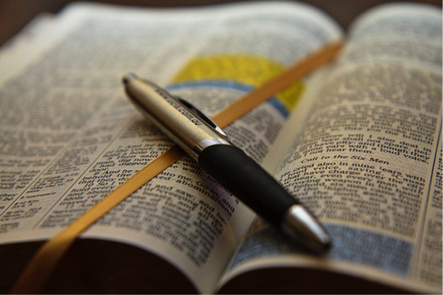 Open Bible with pen